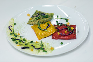 Pancakes of different color on a plate. We prepare with children