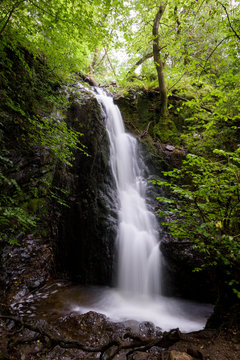 Angel white waterfall in lush and green forest England