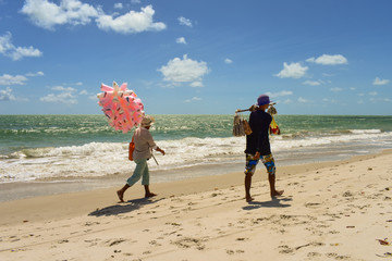 Ilha de Itamaraca, Brazil - Circa December 2018: Hawkers selling cotton candy and roasted cashew...