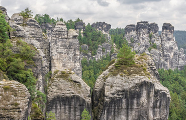 Fototapeta na wymiar Rathen, Germany - The Bastei is a rock formation towering 194 metres above the Elbe River in the Elbe Sandstone Mountains, and one of the main attraction of the Saxon Switzerland National Park