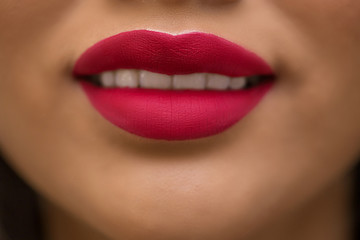 Close - up of beautiful smile swarthy Asian model with red lipstick on her lips