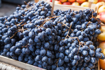 dark blue grapes in basket ready for sale