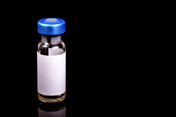 Glass vial medical close-up isolated on a black