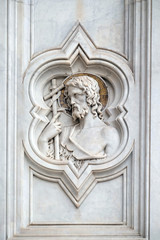 Saint John the Baptist, relief on the facade of Basilica of Santa Croce (Basilica of the Holy Cross) - famous Franciscan church in Florence, Italy