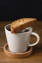 Tasty Sweet Cantuccini Biscuits Italian Sweet Dessert Biscotti on Wooden Background Italian Dessert for Coffee or Wine Biscotti and Cup of Coffee Vertical