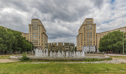 Berlin, Germany - main avenue during of the GDR (East Germany), Karl Marx Allee presents many beautiful buildings. Here in particular an example of its socialist architecture