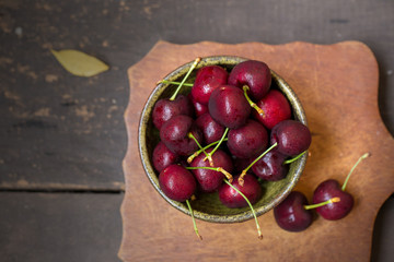 Bowl of Cherries. Red cherries in a bowl on wooden background