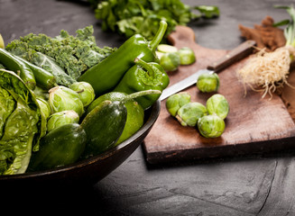 Green health food, fruits and vegetables on black background.