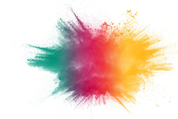 Multi color powder explosion on white background.Red yellow and green dust exhale in the air.