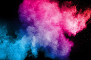 Multi color powder explosion  on black background.