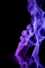 Abstract backgrounds and wallpapers. Colorful smoke on black background..