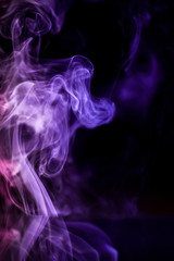 Abstract backgrounds and wallpapers. Colorful smoke on black background..