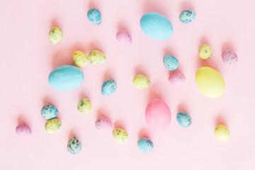 Painted easter eggs lying on pink background