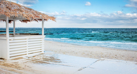 Bungalow on a sandy beach by the sea. Concept Vacation at sea in the summer.