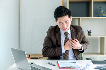 Businessman is heart disease sudden chest pain in the office.