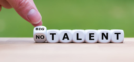 Hand turns a dice and changes the expression "no talent" to "big talent".