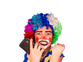 Portrait of happy funny clown kid holding smartphone and angry because of bad news. Negative and expression concept.pantomimic expression. emotions. April Fool's Day, April 1. Isolated on white.