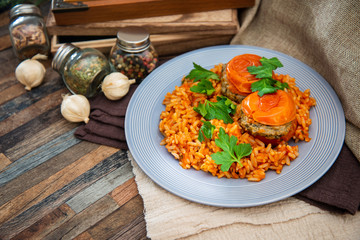stuffed tomatoes with rice on a white plate