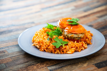 stuffed tomatoes with rice on a white plate