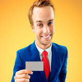 Businessman showing business or plastic card, with copyspace