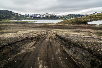 Beautiful Landmanalaugar gravel dust road way on highland of Iceland, Europe. Muddy tough terrain for extreme 4WD 4x4 vehicle. Landmanalaugar landscape is famous for nature trekking and hiking. © InfiniteFlow