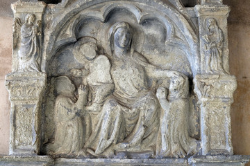 Fototapeta na wymiar Virgin Mary with baby Jesus, relief in the Santa Maria Novella Principal Dominican church in Florence, Italy
