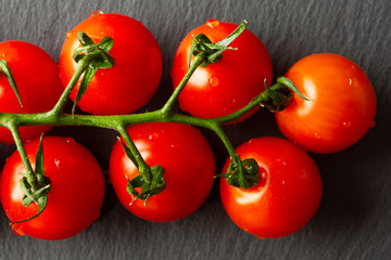 Close up of seven cherry tomatoes on the branch