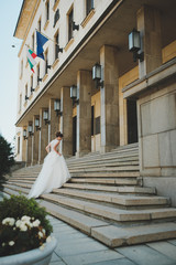 Bride walking stairs in city