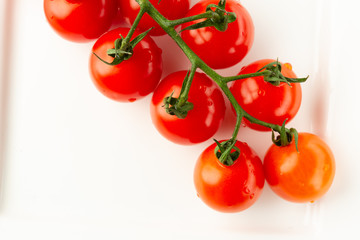 Top view of cherry tomatoes on white surface