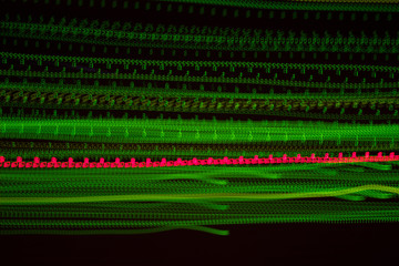 abstract light effect with chaotic red and green lines. Dark futuristic background.
