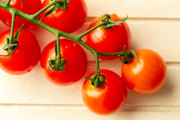 Top view of cherry tomato branch on striped surface