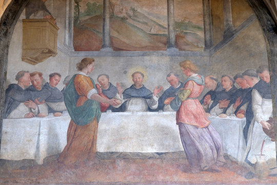 San Dominic in Mensa fed by the Angels, fresco by Santi di Tito in the cloister of Santa Maria Novella Principal Dominican church in Florence, Italy