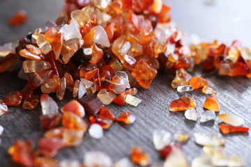 Natural brown stones for jewelry on wooden table