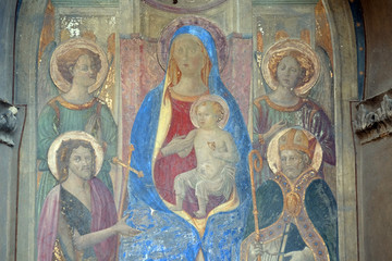 Madonna Enthroned with Saints and Angels, fresco by Francesco Fiorentino, corner of Via della Scala and Piazza Santa Maria Novella in 1420, in Florence, Italy