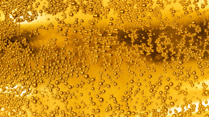bubbles in glass of beer abstract background