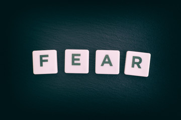 Word Fear on a black slate background