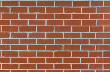 Natural red brick wall texture background with grey grout filling
