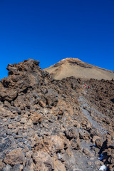 Trekking in the middle of lava fields ascending Teide volcano crater