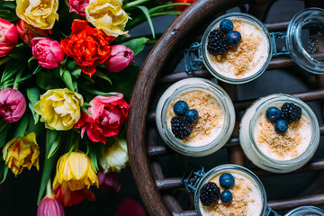 Homemade Cheesecake in the Jar with Colourful Bouquet of Tulips