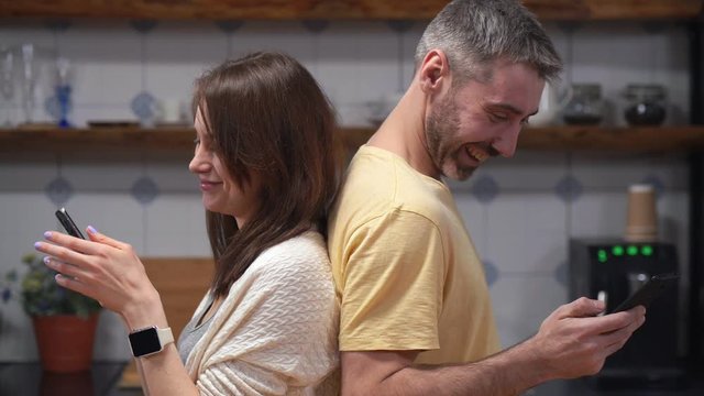 Smiling caucasian couple in kitchen