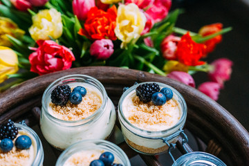 Homemade Cheesecake in the Jar with Colourful Bouquet of Tulips