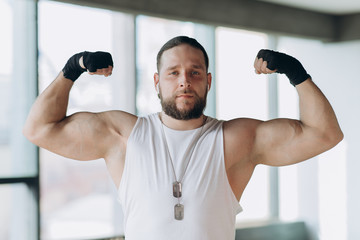 Strong, muscular man, Apollo shows his muscles, torso, vein Delta press