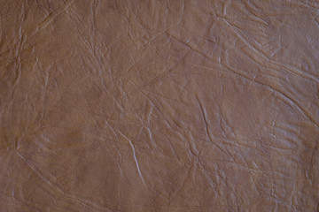 The texture of the material of leather brown, close-up.