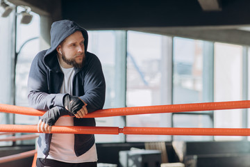 Boxer wearing boxing bandages on hands looking on camera