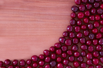Juicy and ripe red cherries lie on the table, the scent of summer.