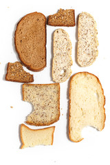 Set of several slices of different bread on a white background.