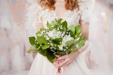 Lush wedding bouquet in the hands of the bride. A girl in a wedding dress holding a bouquet