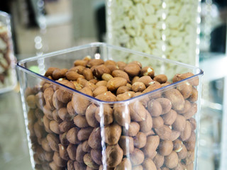Nut mix in glass jars, hazelnuts, almonds, cashew on white background. Selective focus, copy space.