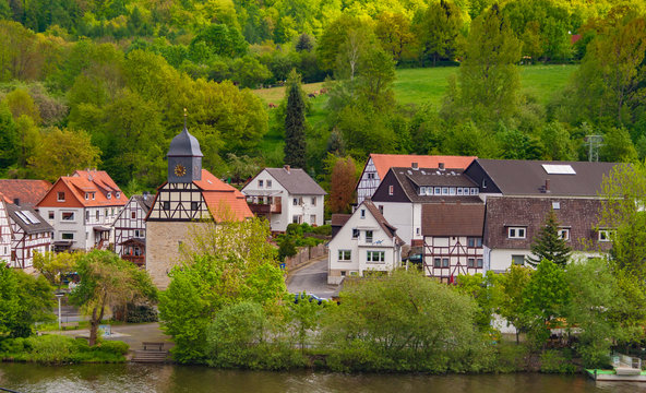 Nice close panoramic view of the small village Staufenberg in Lower Saxony, Germany at the Fulda riverside with the large and densely wooded M&uuml;nden Nature Park in the background on a nice spring day.