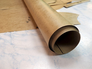 roll of drawing paper and patterns on the table